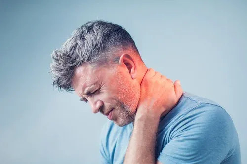 Man holding the back of his neck in pain